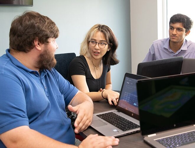 Interns sitting at a table