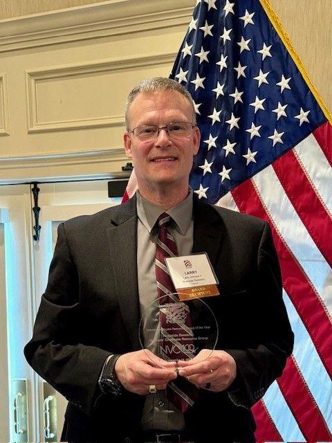 Larry Johnson receives NVC award on behalf of the Riverside Research Veterans' Employee Resource Group (VERG).
